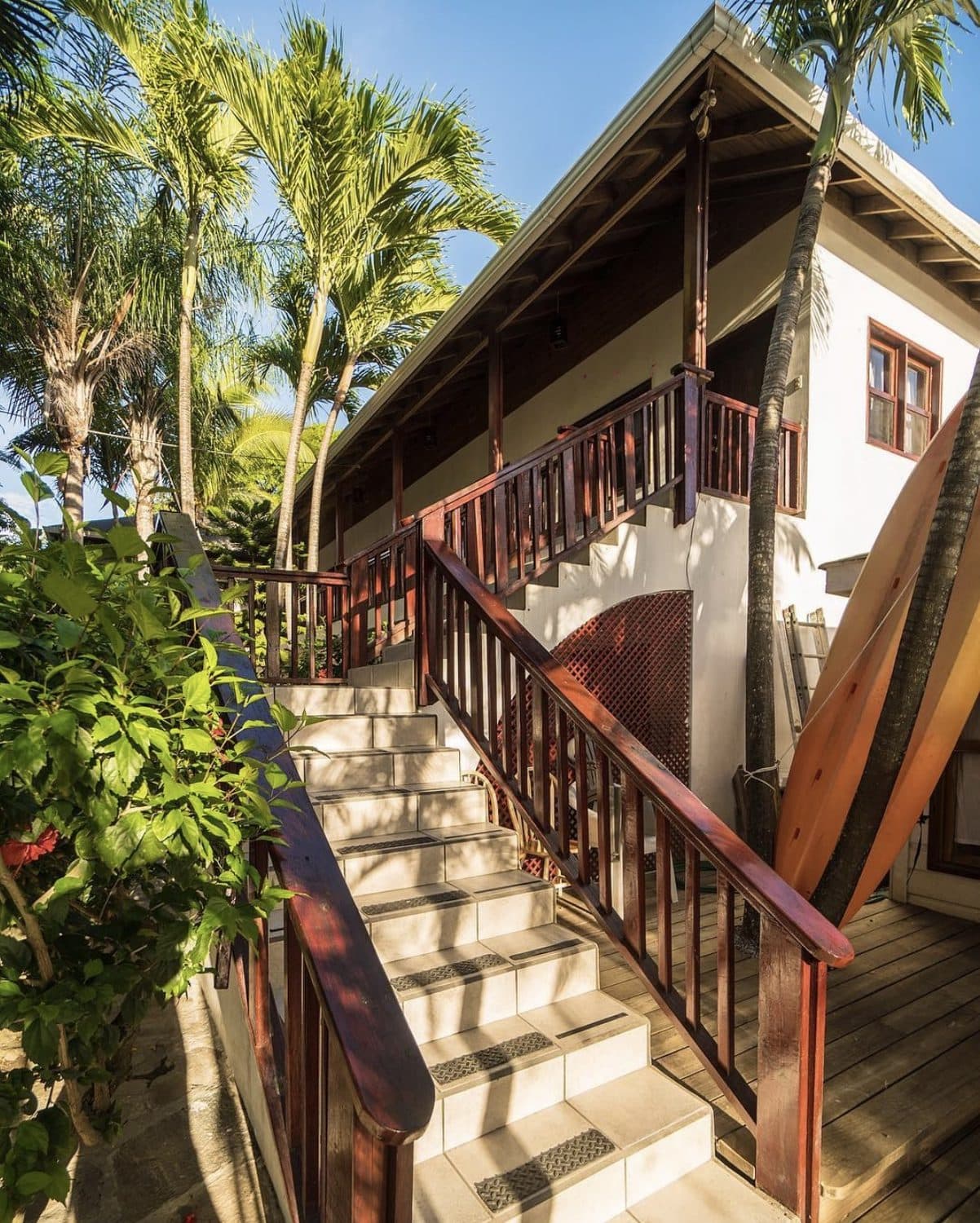 The resort's wooden stairs and balconies among the palms