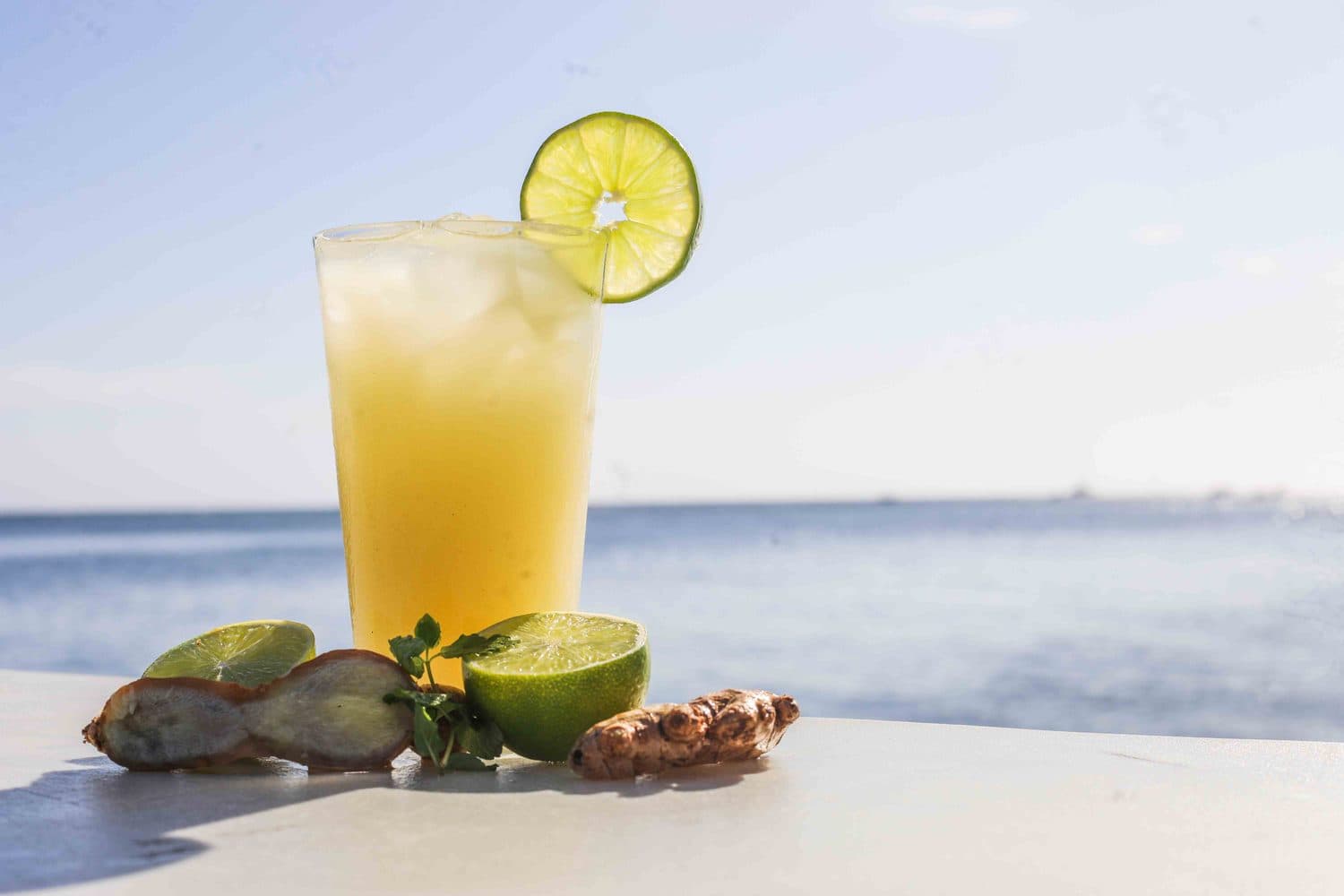 A cocktail with fresh lime on the beach