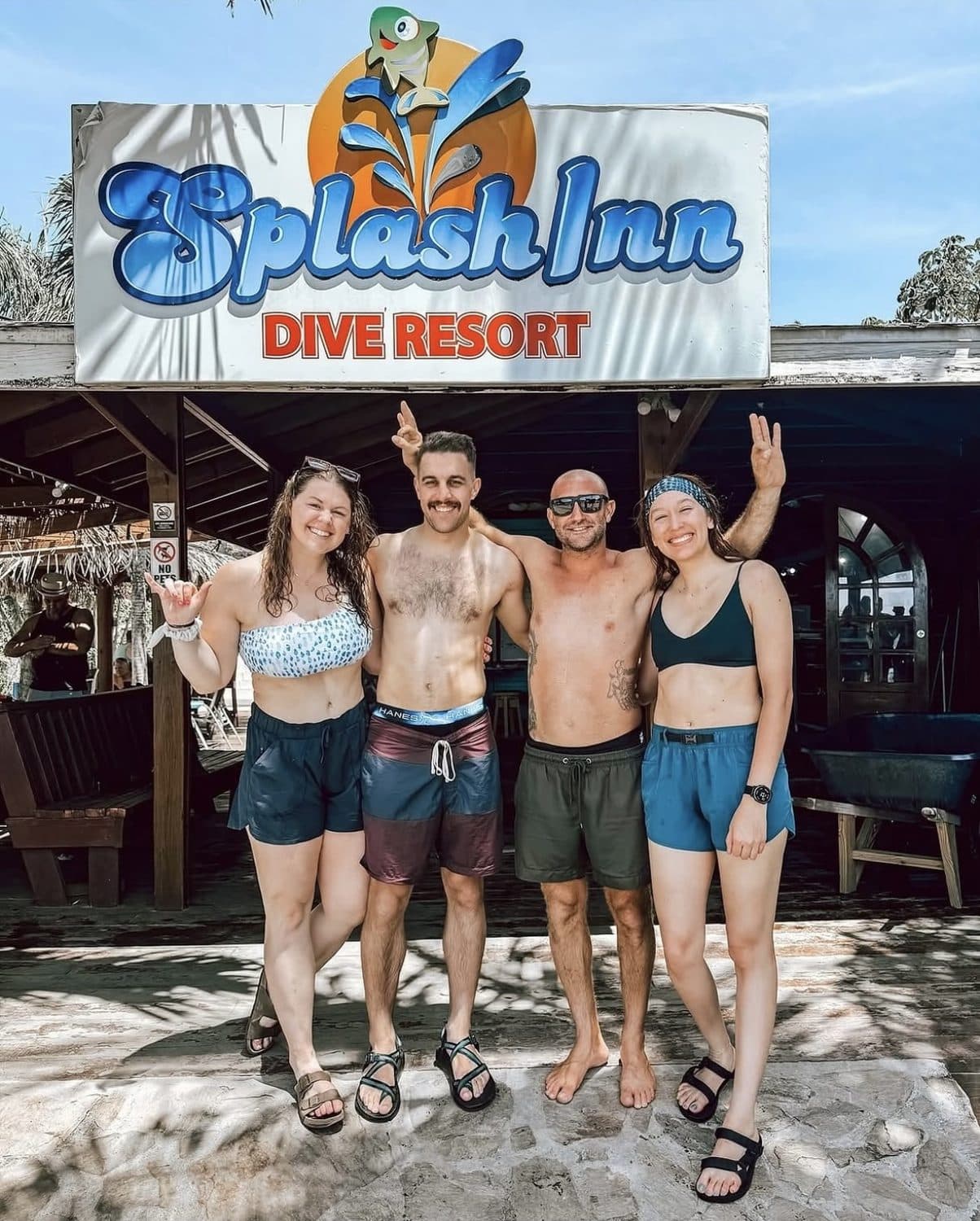Four guests outside the Splash Inn Dive Resort dive shop